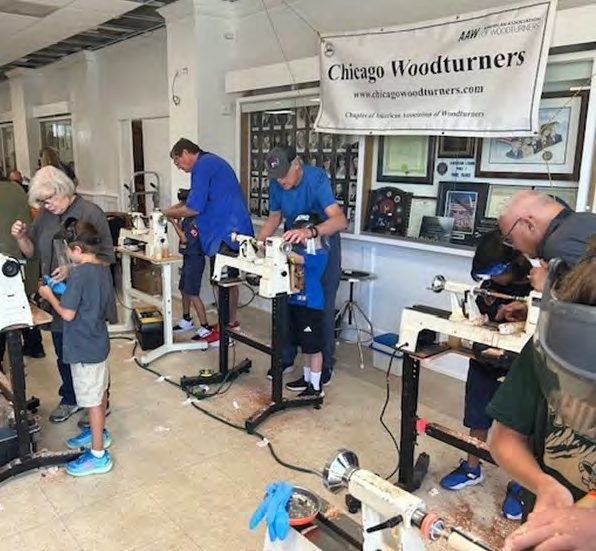 Chicago Woodturners members working at lathes during a demonstration session