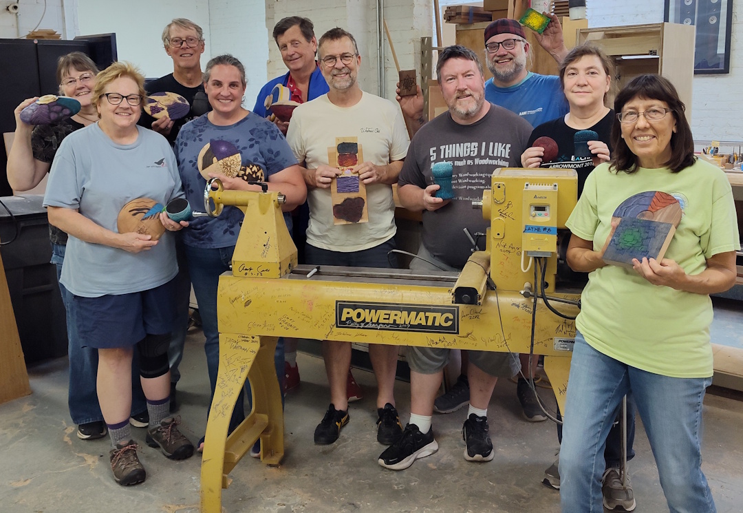 Chicago Woodturners members gathered together with their work in the shop