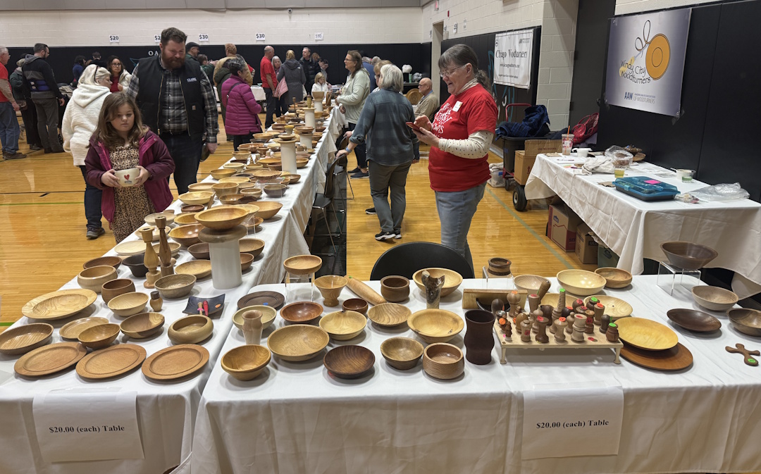Chicago Woodturners display tables of turned work at a 2025 event